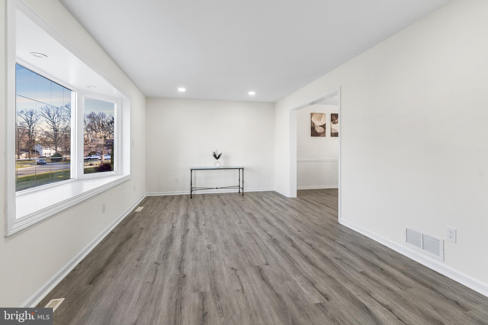 210 West Silver Fox Road Newark, DE 19702 - Photo 4 of 43 a view of empty room with wooden floor and fan