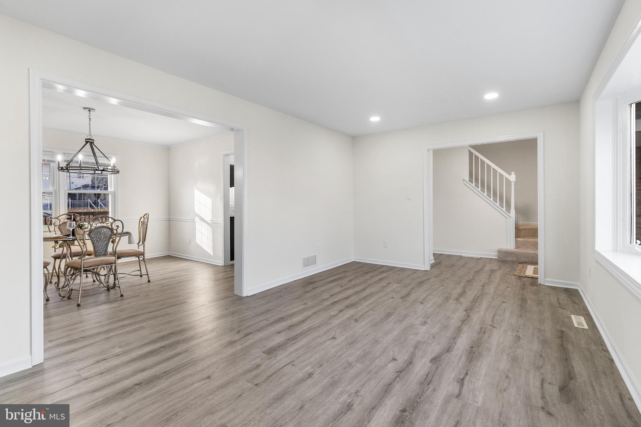 210 West Silver Fox Road Newark, DE 19702 - Photo 5 of 43 a view of empty room with wooden floor and chair