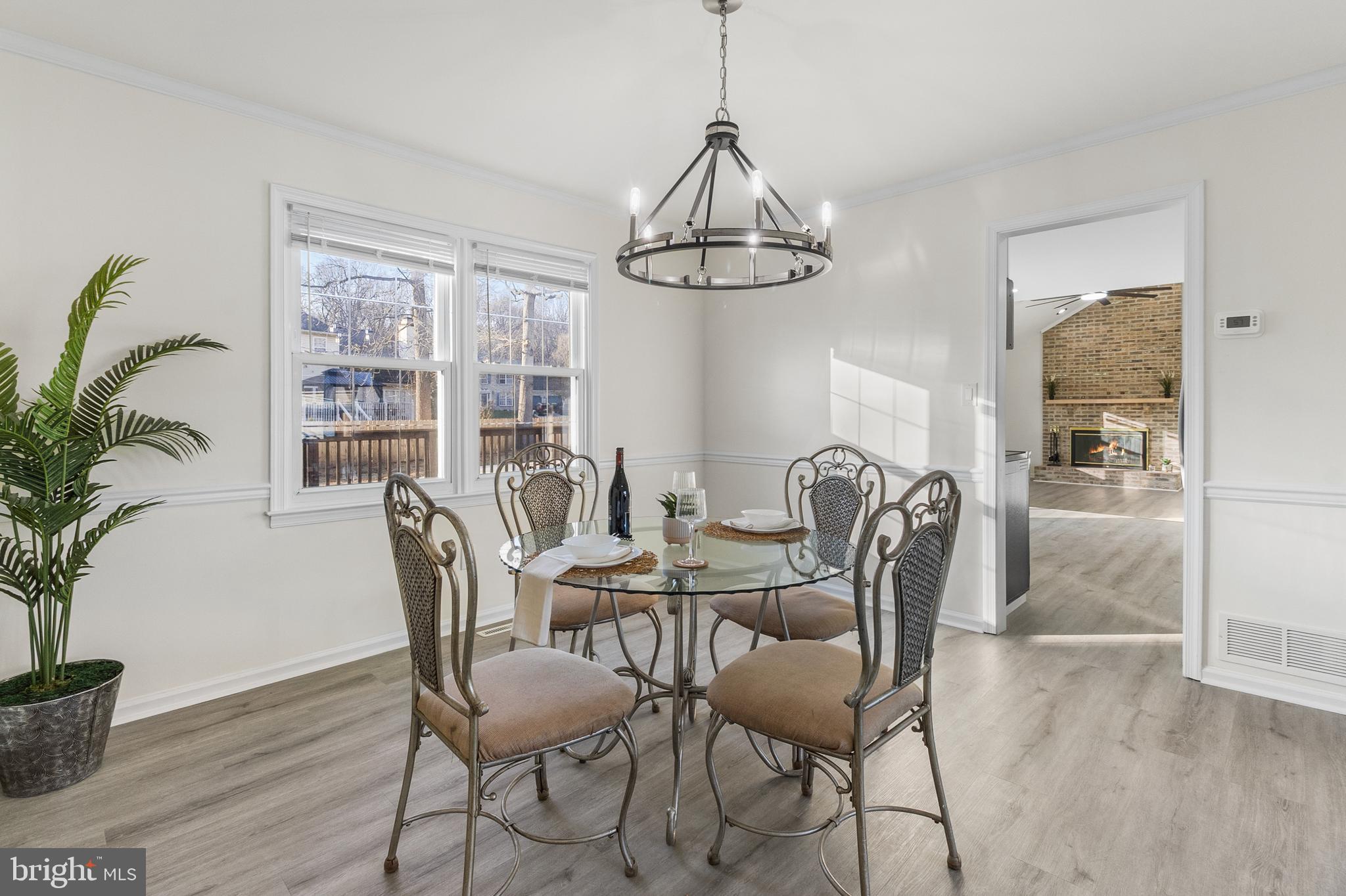 210 West Silver Fox Road Newark, DE 19702 - Photo 8 of 43 a view of a dining room with furniture window and wooden floor