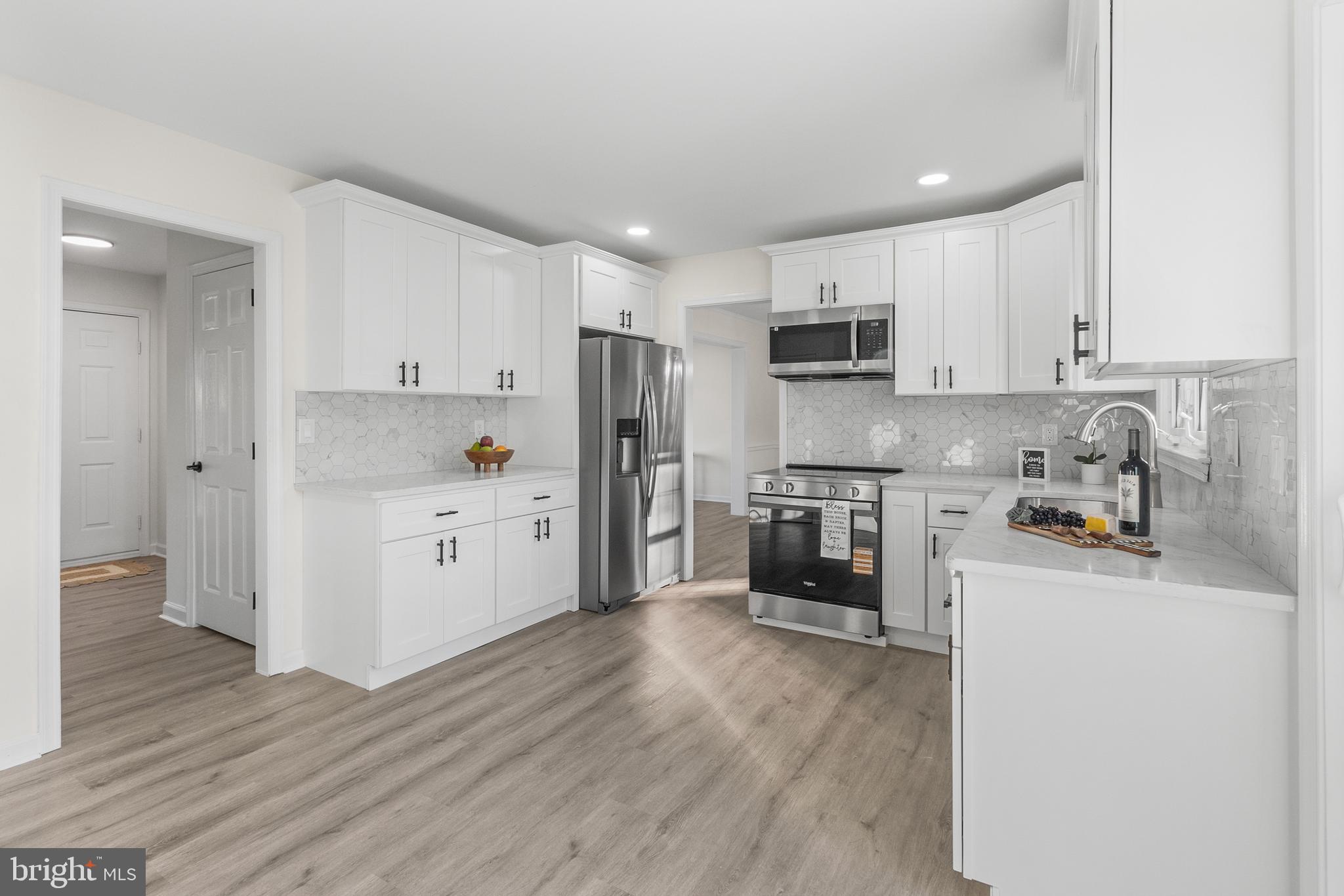 210 West Silver Fox Road Newark, DE 19702 - Photo 10 of 43 a kitchen with granite countertop white cabinets and stainless steel appliances