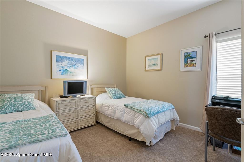 Undisclosed Address Vero Beach, FL 32967 - Photo 17 of 34 a bedroom with a bed and a desk