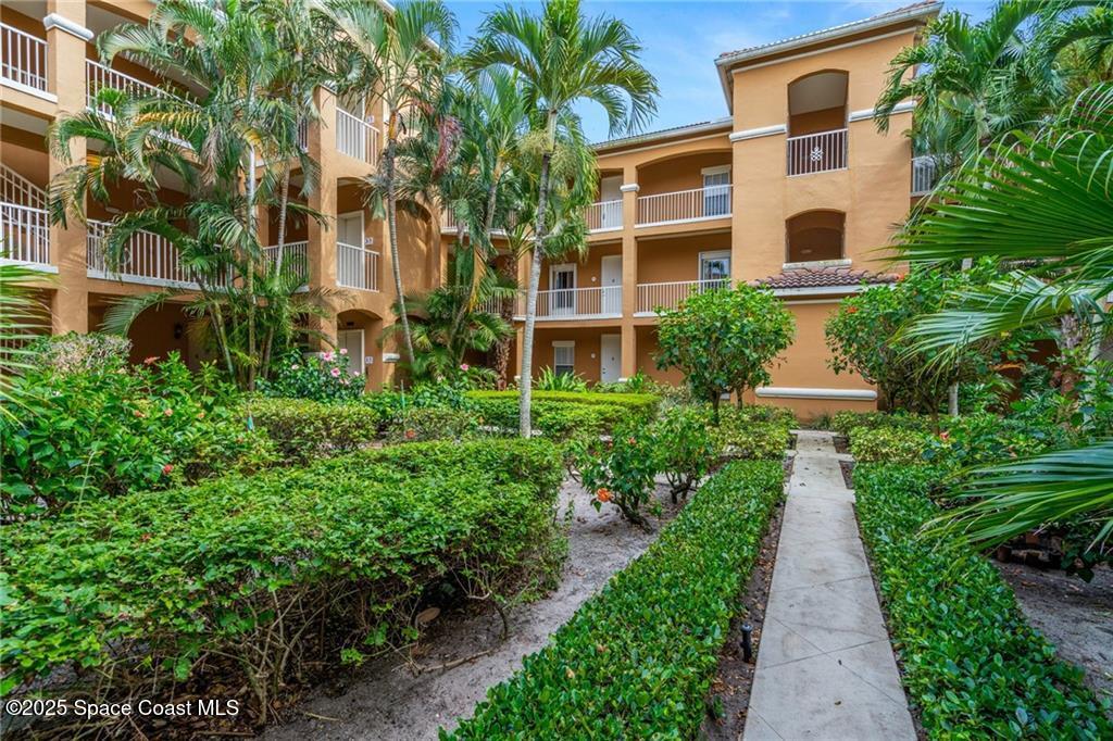 Undisclosed Address Vero Beach, FL 32967 - Photo 22 of 34 a view of a multi story building with a yard