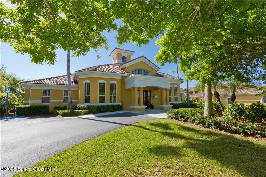 Undisclosed Address Vero Beach, FL 32967 - Photo 27 of 34 a front view of a house with a garden