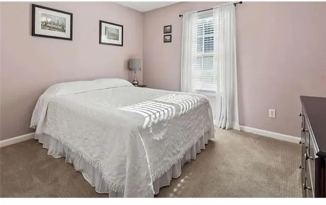 a bathroom with a sink vanity mirror and toilet