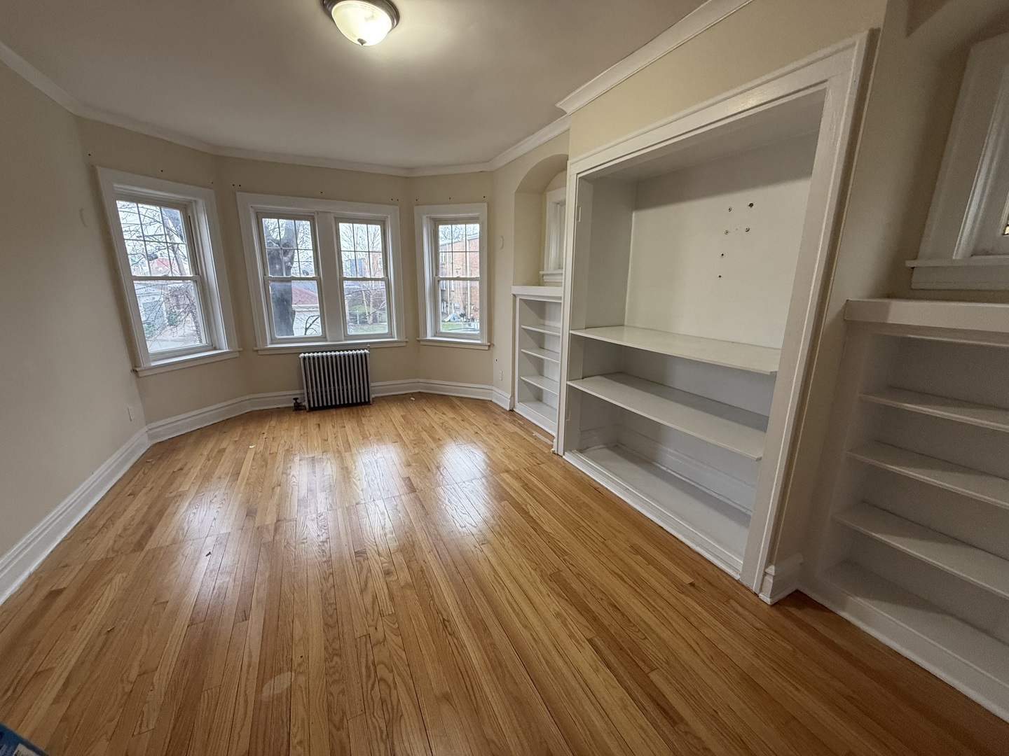 6839 21st Street, Unit 2N Berwyn, IL 60402 - Photo 3 of 12 a view of an empty room with a window and wooden floor