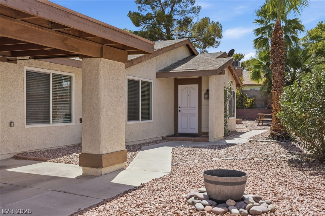 3971 Spring Leaf Drive Las Vegas, NV 89147 - Photo 44 of 48 A welcoming path leads to the front entry of this property, framed by mature landscaping and a practical carport.