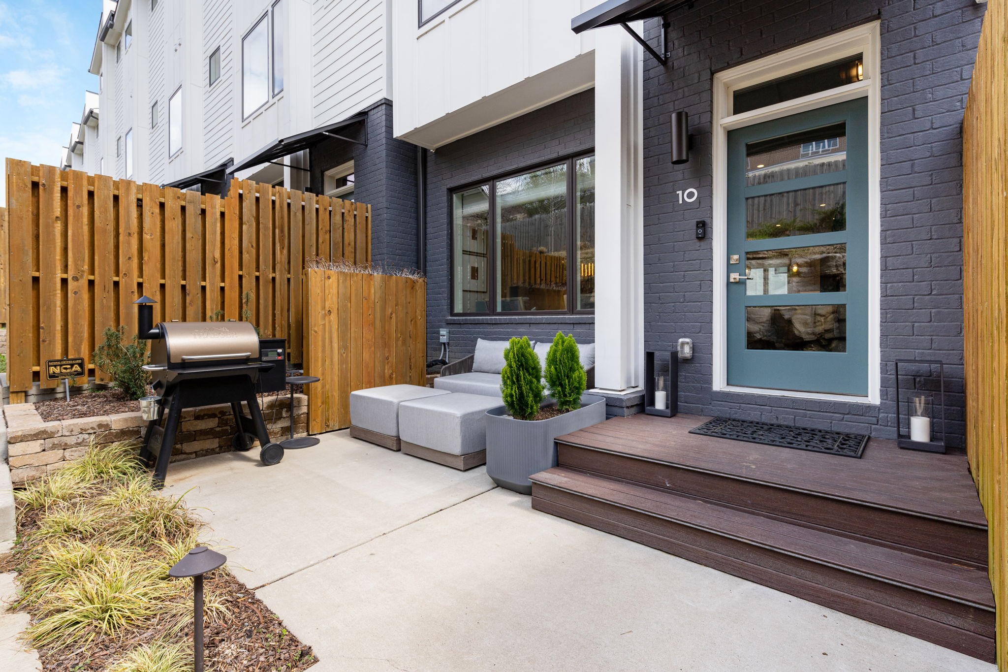 a view of backyard with outdoor seating and stairs