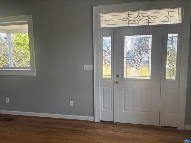 a view of an entryway with wooden floor