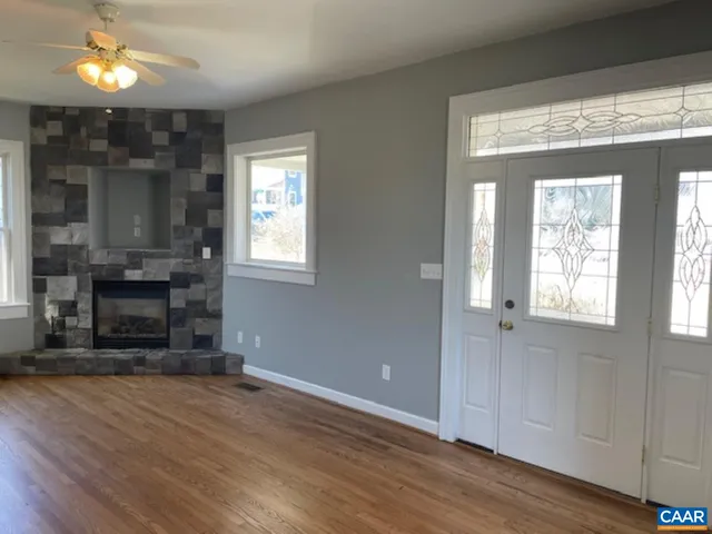 wooden floor in an empty room with a fireplace