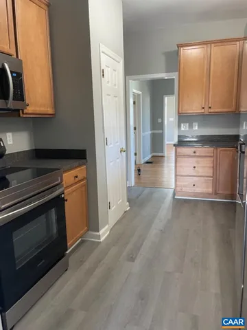 a kitchen with stainless steel appliances granite countertop a stove and a microwave oven