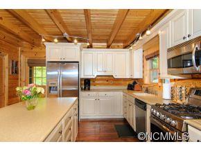 505 Howland Road Asheville, NC 28804 - Photo 11 of 24 a kitchen with stainless steel appliances granite countertop a sink a stove and a refrigerator