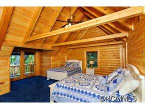 505 Howland Road Asheville, NC 28804 - Photo 19 of 24 a bedroom with a bed and wooden floor