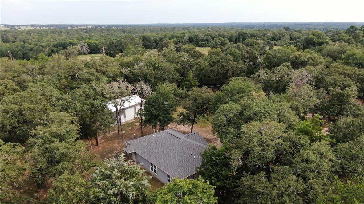 an aerial view of a house with yard