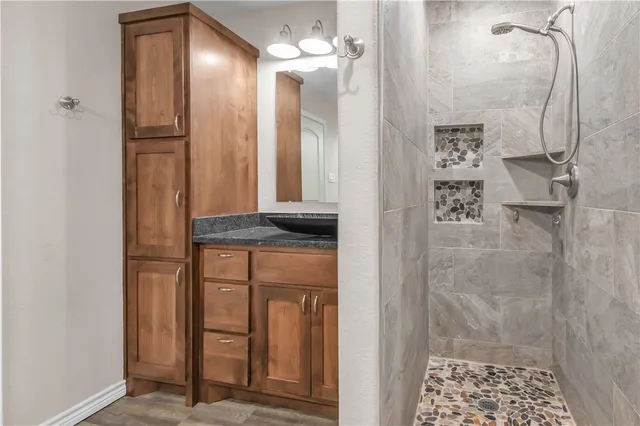 a bathroom with a shower and a mirror