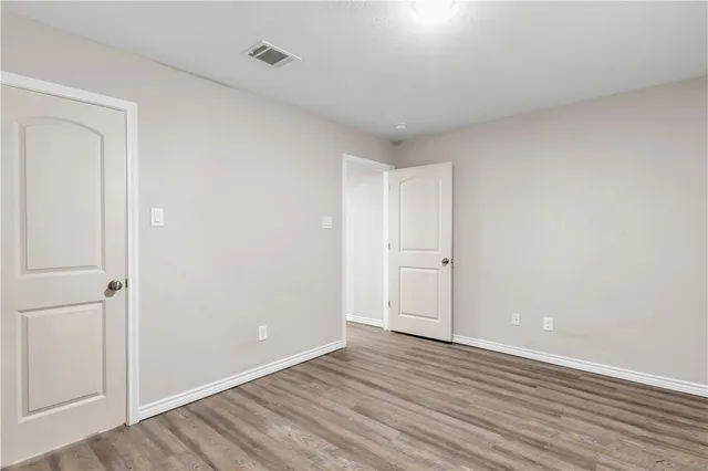 a view of an empty room and wooden floor