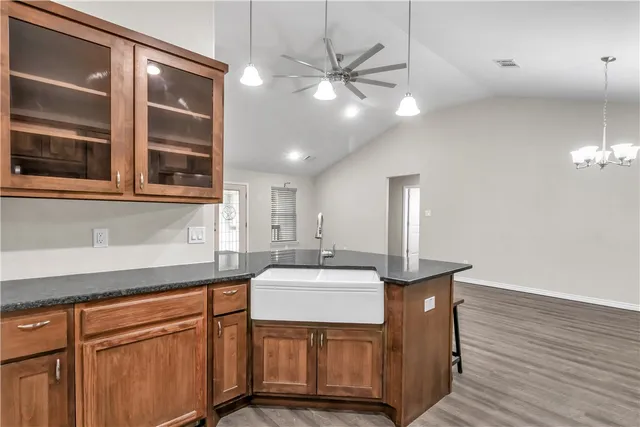 a kitchen with a sink cabinets and wooden floor