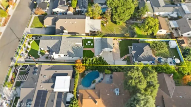 a view of a patio with table and chairs under an umbrella