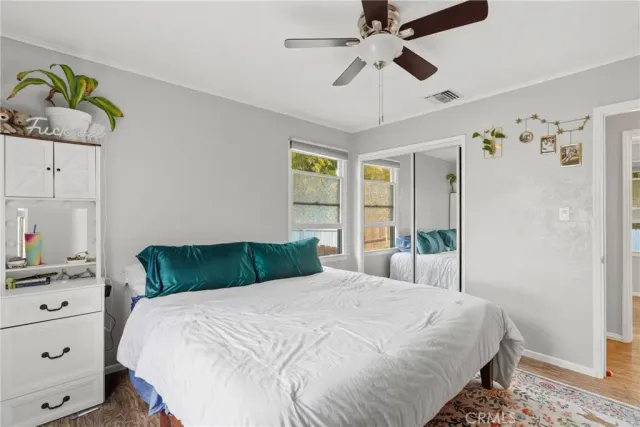 a bedroom with a bed dresser and a window