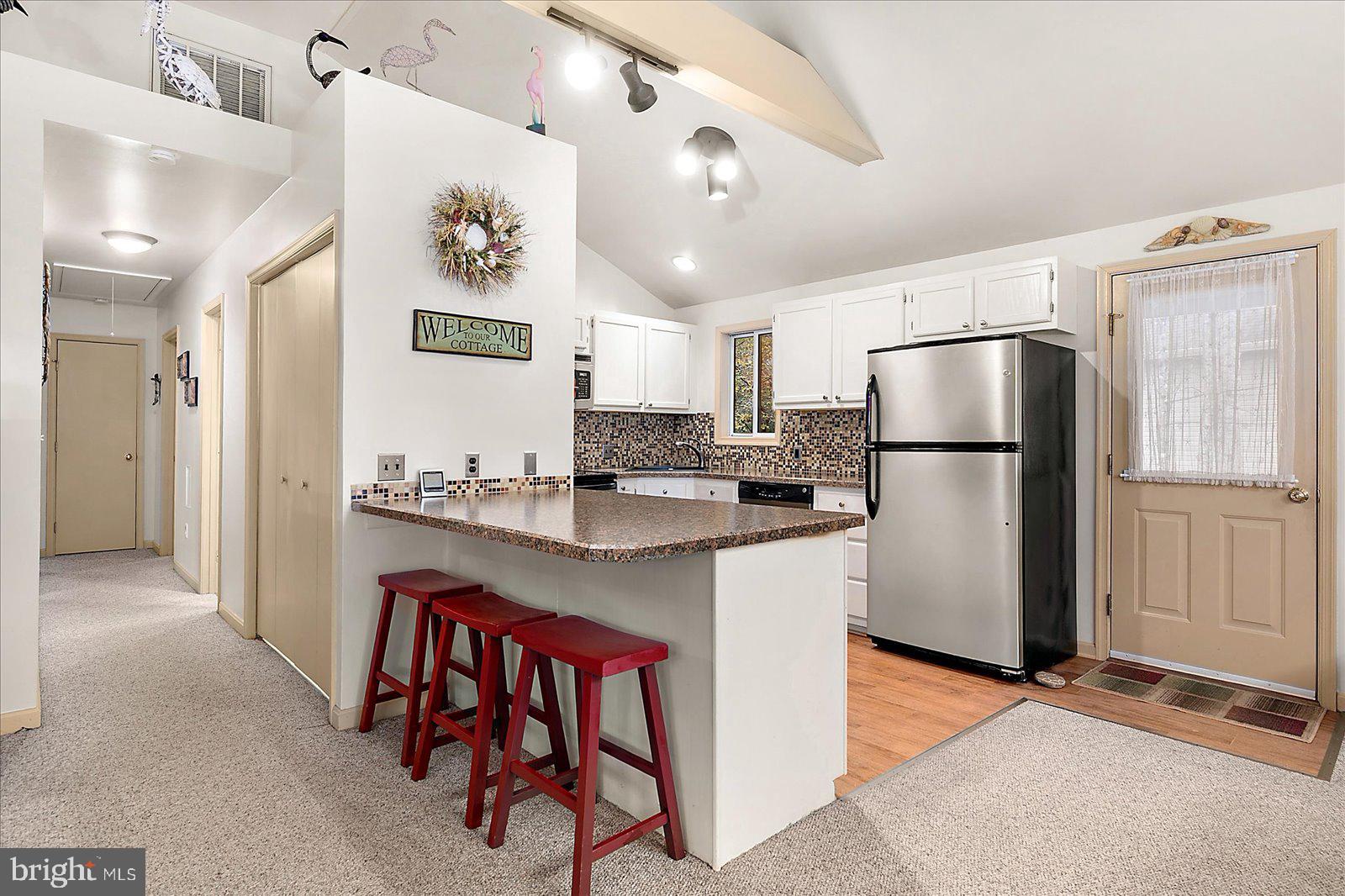 10 Harpoon Road Ocean Pines, MD 21811 - Photo 12 of 44 a kitchen with refrigerator cabinets and wooden floor