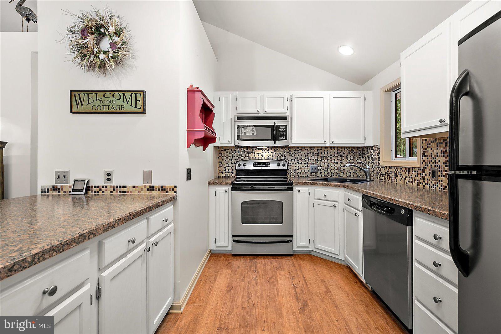 10 Harpoon Road Ocean Pines, MD 21811 - Photo 15 of 44 a kitchen with stainless steel appliances granite countertop a sink stove and refrigerator