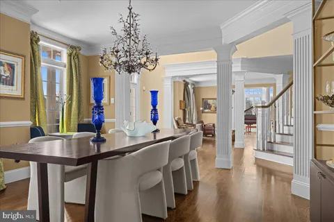 a room with chandelier and wooden floor