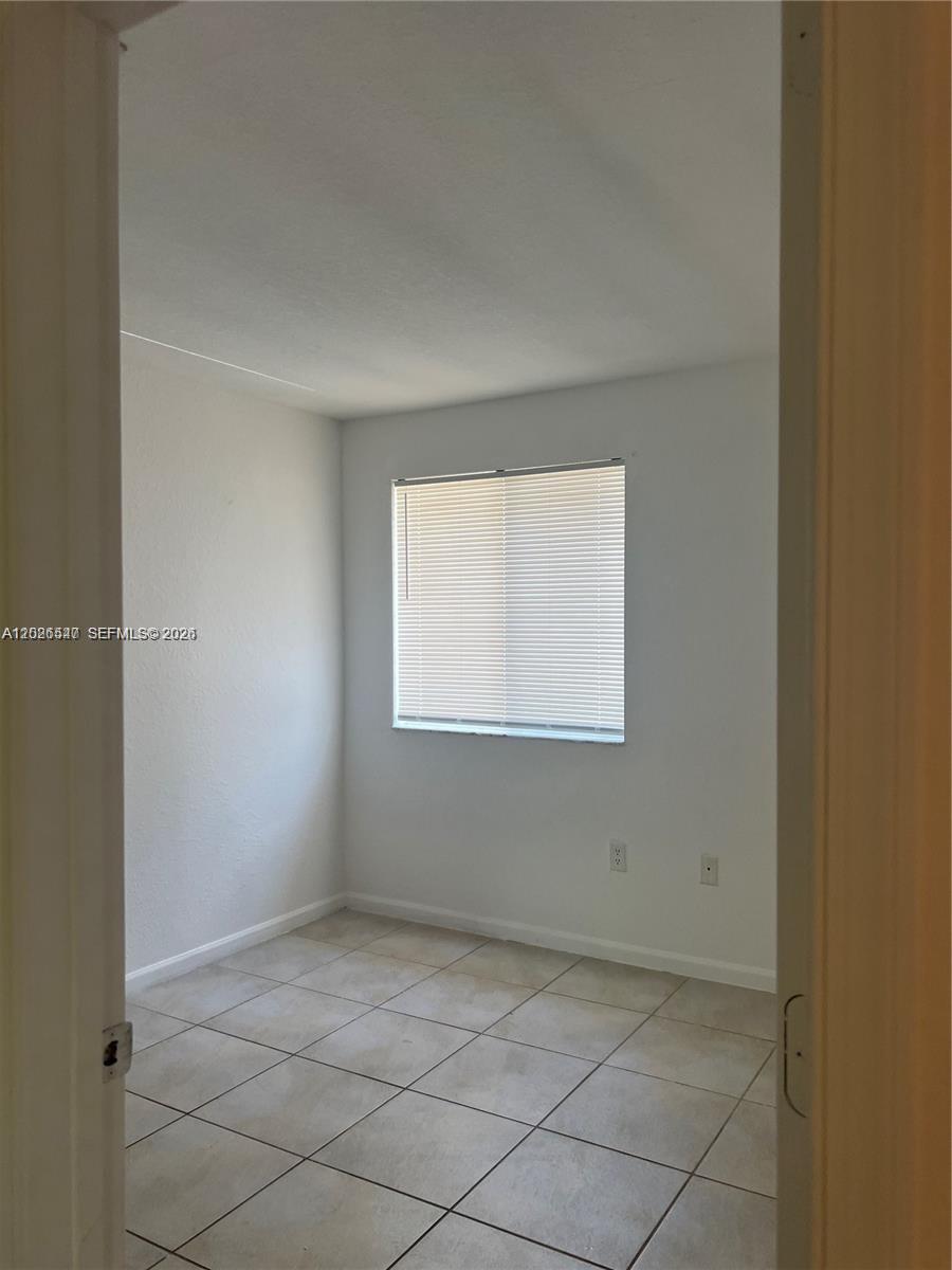 2910 Southeast 15th Road, Unit 55 Homestead, FL 33035 - Photo 11 of 13 an empty room with a window