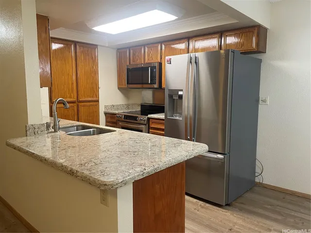 a kitchen with stainless steel appliances granite countertop a refrigerator and a sink