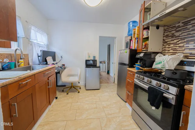 a kitchen with a stove top oven and cabinets