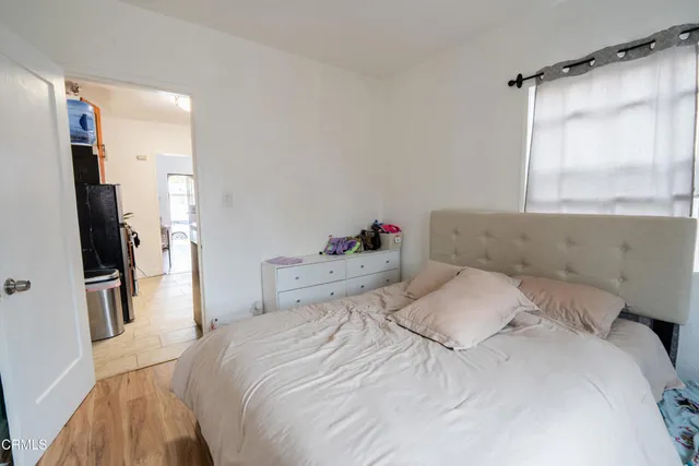 a bedroom with a bed and a large window