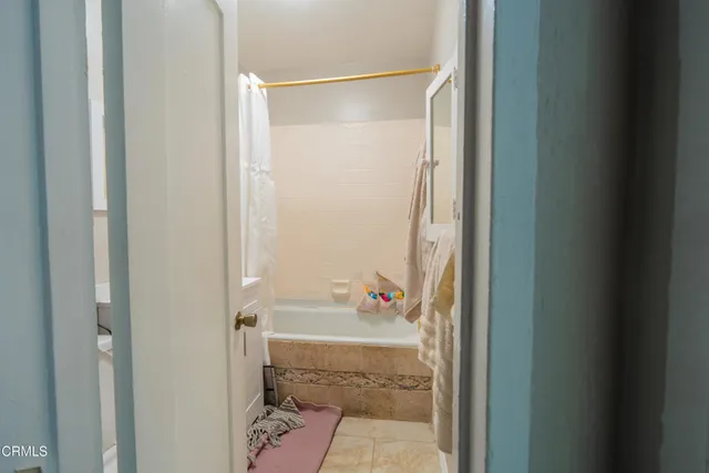 a bathroom with a shower and a sink