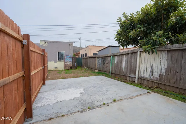 a view of a backyard with wooden fence