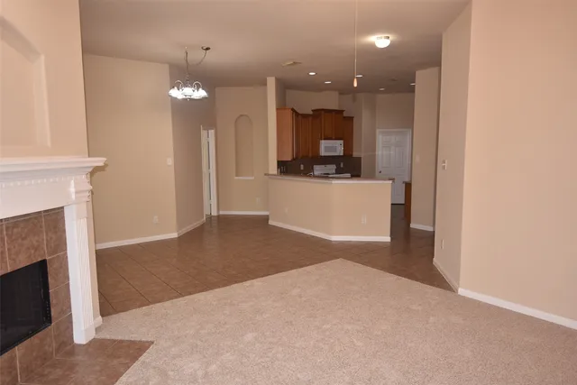 a view of a kitchen with a sink and a fireplace