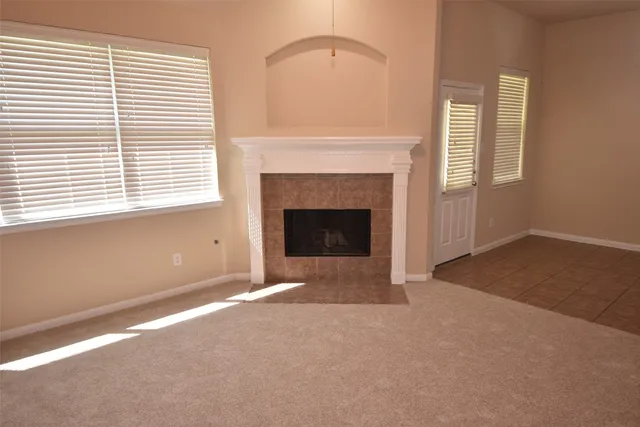 a view of empty room with a fireplace