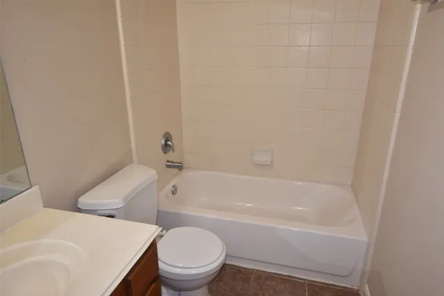 a white bath tub sitting next to a white toilet