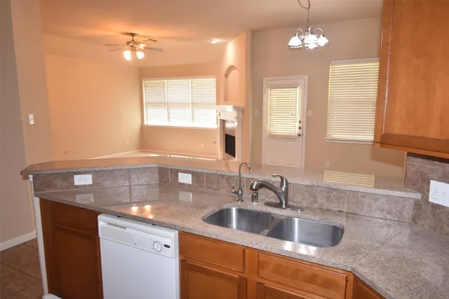 a kitchen with a sink cabinets and window