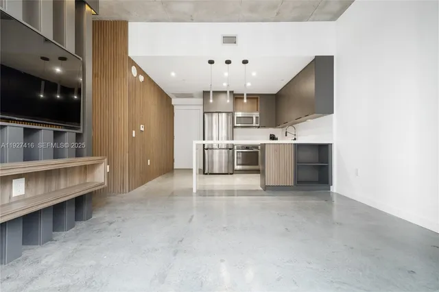 a kitchen with stainless steel appliances a kitchen island a stove and a sink