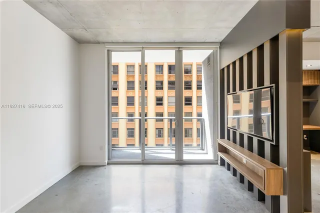 a view of an empty room with a window