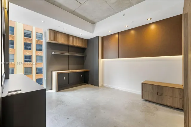 a view of an empty room with a kitchen