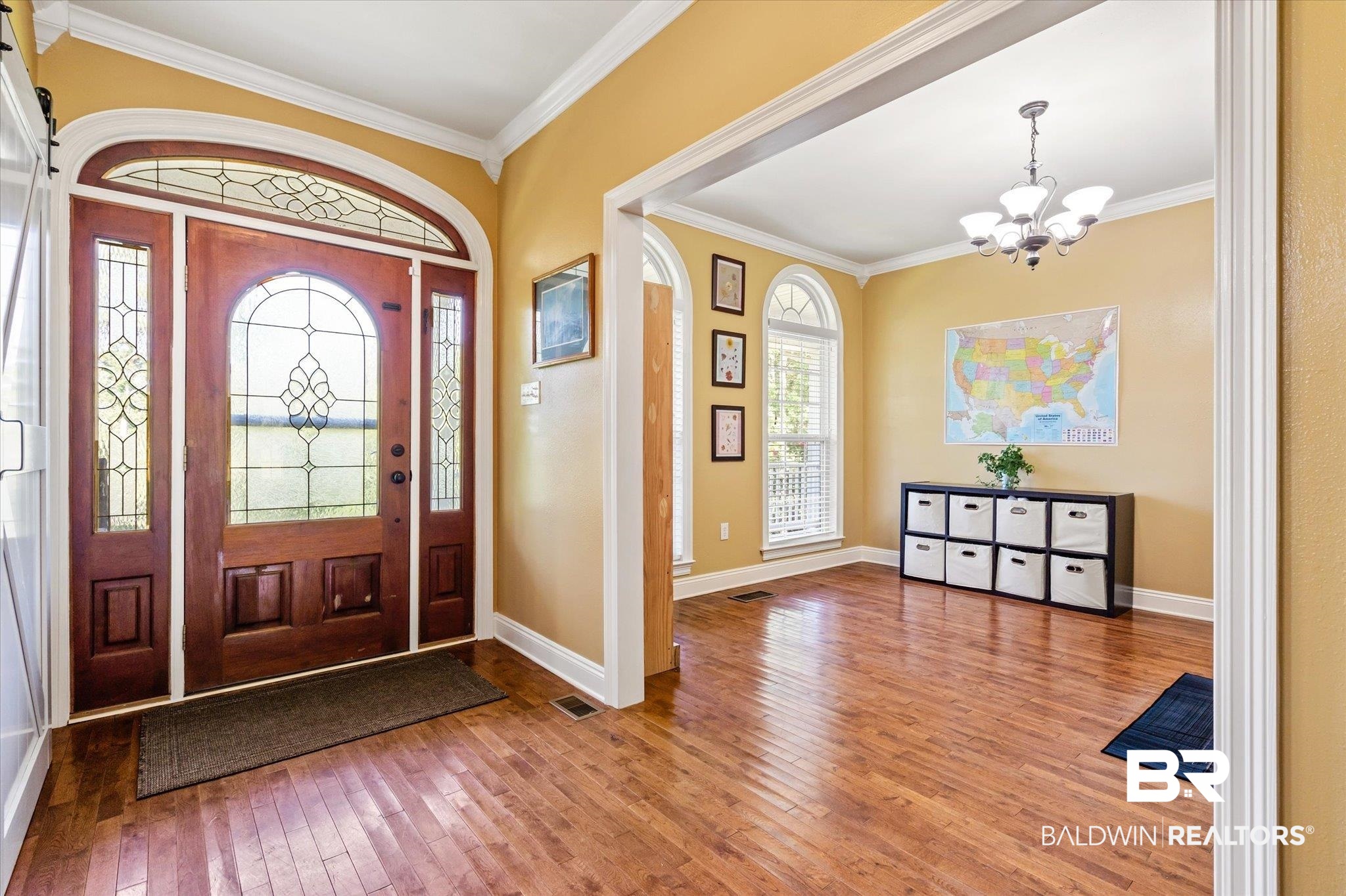 72 Limestone Drive Jackson, AL 36545 - Photo 14 of 38 Entrance foyer featuring ornamental molding, hardwood / wood-style flooring, and an inviting chandelier