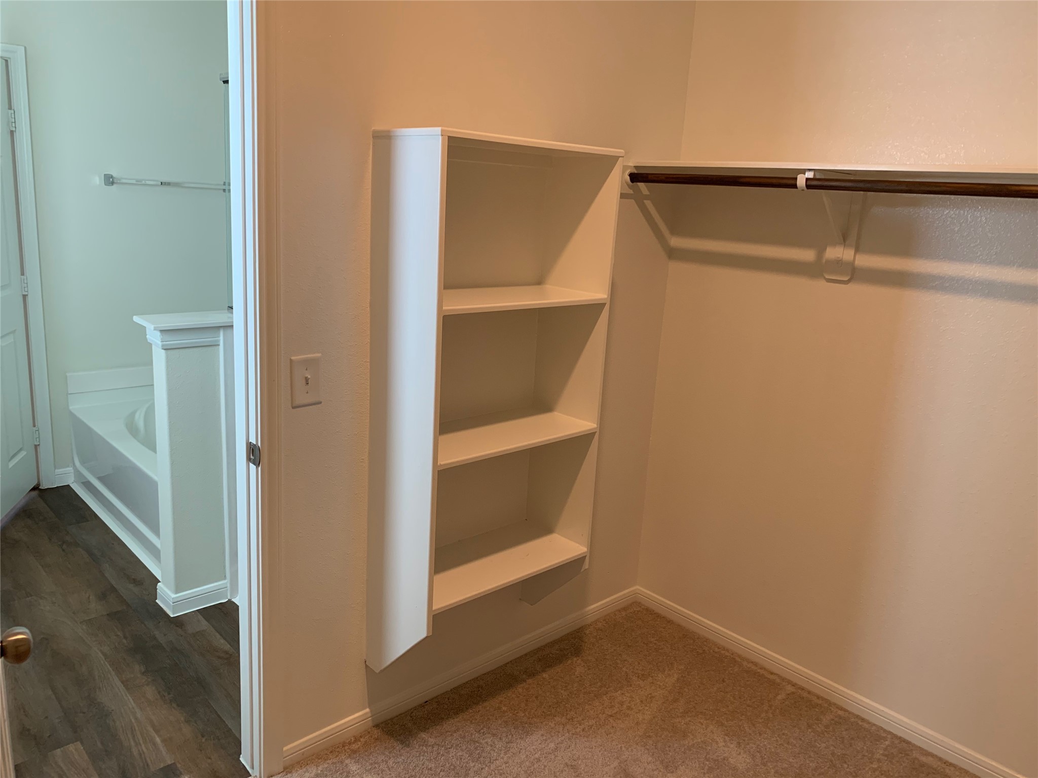 4622 Falling Sun Drive Houston, TX 77069 - Photo 11 of 28 a view of walk in closet with empty racks