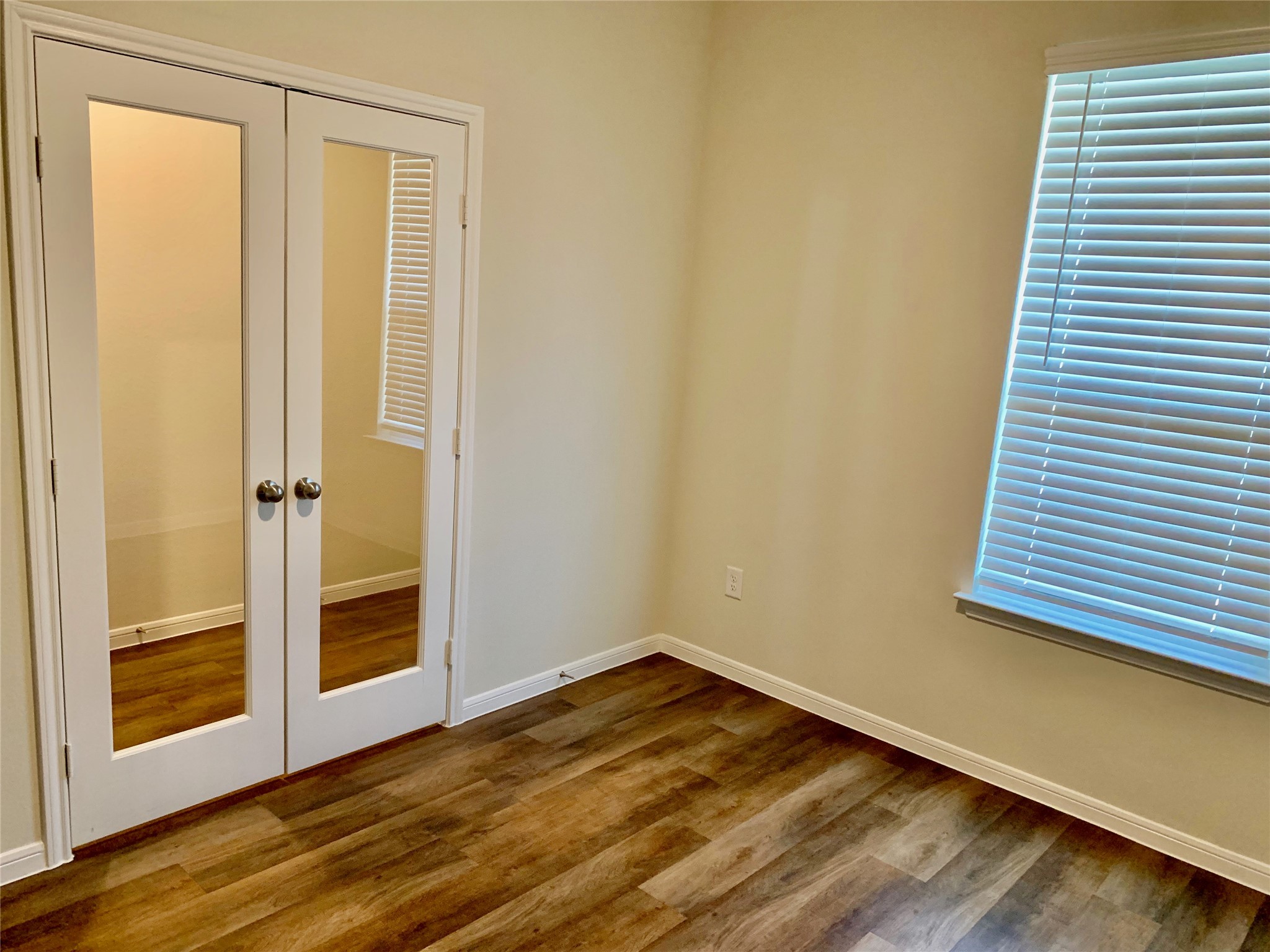 4622 Falling Sun Drive Houston, TX 77069 - Photo 13 of 28 a view of an empty room with wooden floor and a window