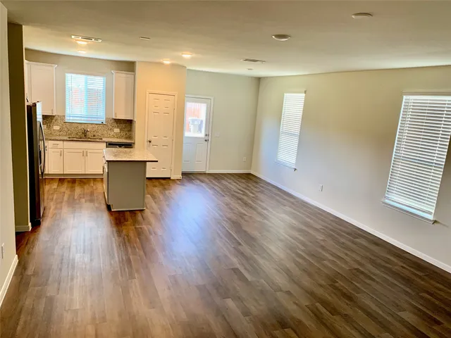 a view of kitchen with wooden floor and electronic appliances