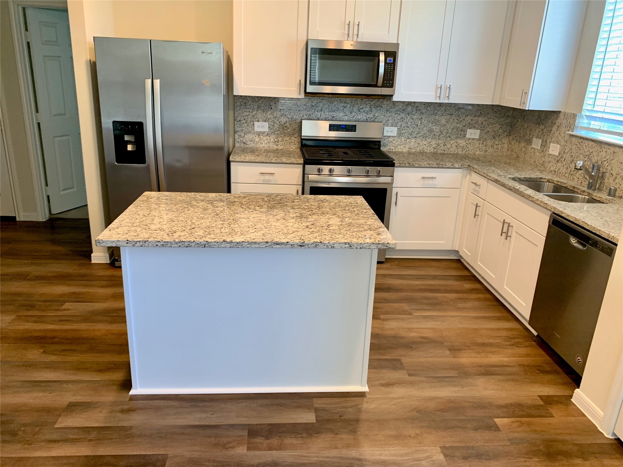 4622 Falling Sun Drive Houston, TX 77069 - Photo 5 of 28 a kitchen with stainless steel appliances kitchen island granite countertop a refrigerator a stove top oven a sink and dishwasher