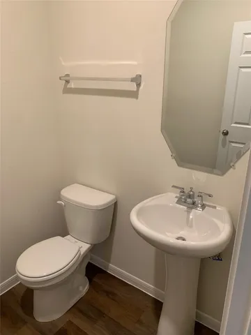 a white toilet sitting next to a bathroom sink