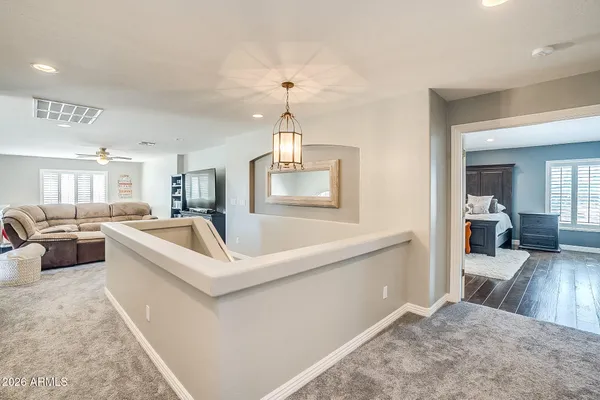 a living room with stainless steel appliances kitchen island furniture and a chandelier