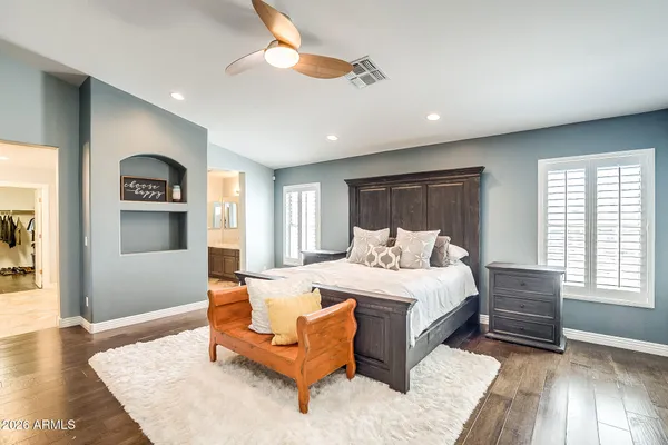 a spacious bedroom with a bed a couch and a window