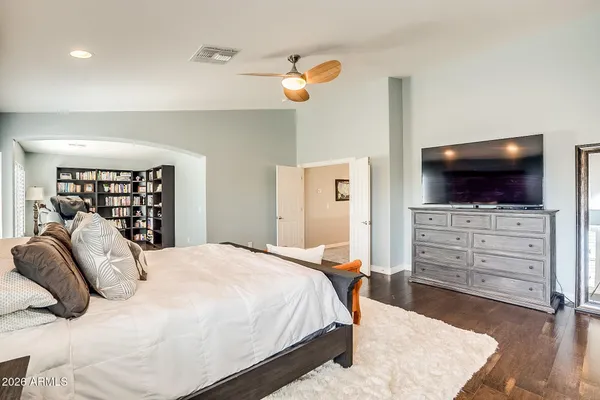 a bedroom with a bed and a flat screen tv