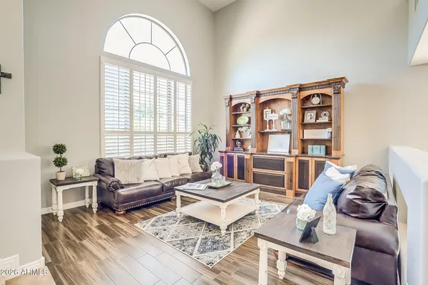 a living room with furniture a table and a large window