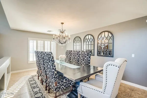 a living room with furniture chandelier and a window