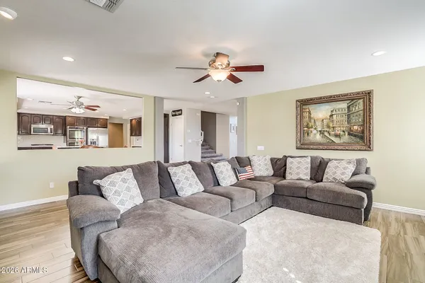 a living room with furniture and painting on the wall
